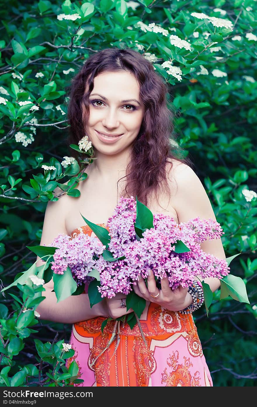 Young woman with lilac flowers