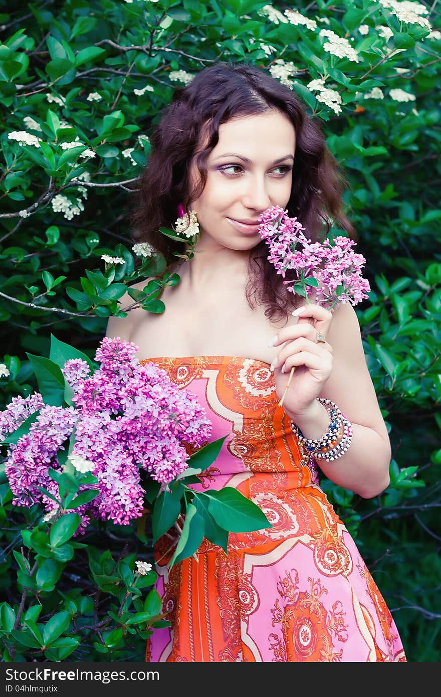 Young woman with lilac flowers