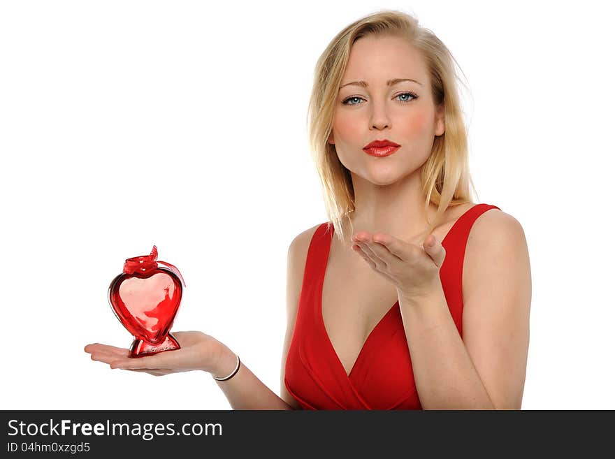 Young Woman wearing a red dress and holding a heart shape isolated on a white background. Young Woman wearing a red dress and holding a heart shape isolated on a white background