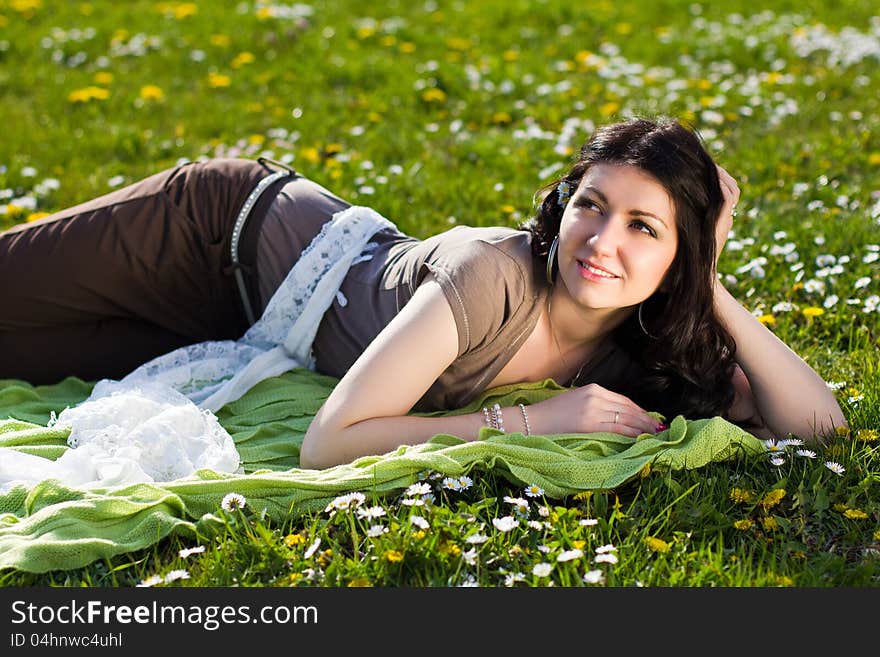 Beautiful Girl Lying On The Grass With Flowers