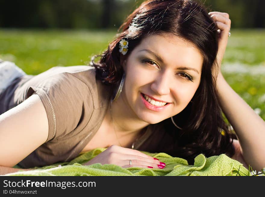 Beautiful Girl Lying On The Plaid In The Park