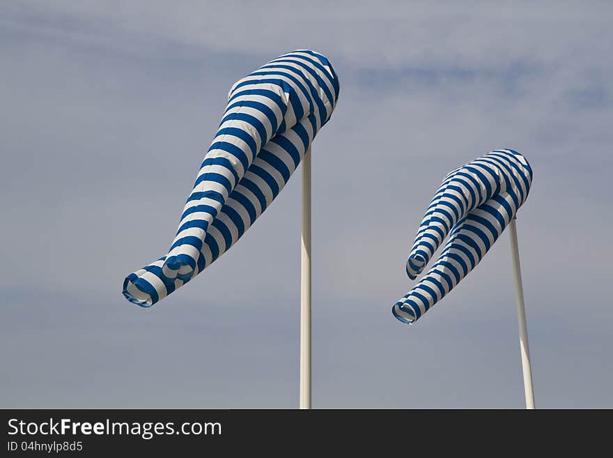 Blue and white windsock blows against a blue sky. Blue and white windsock blows against a blue sky