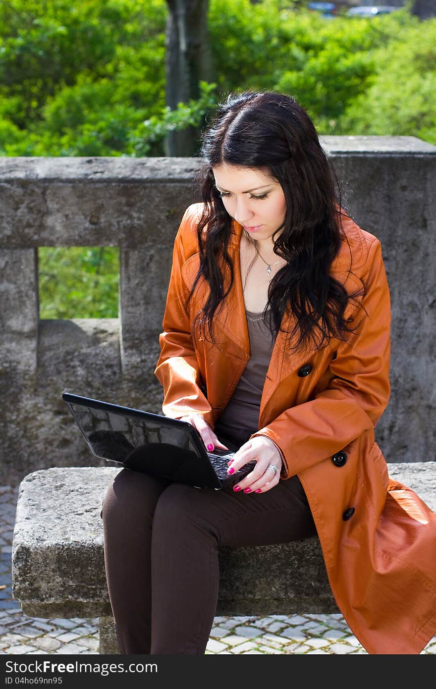 Young Woman Sitting On A Bench