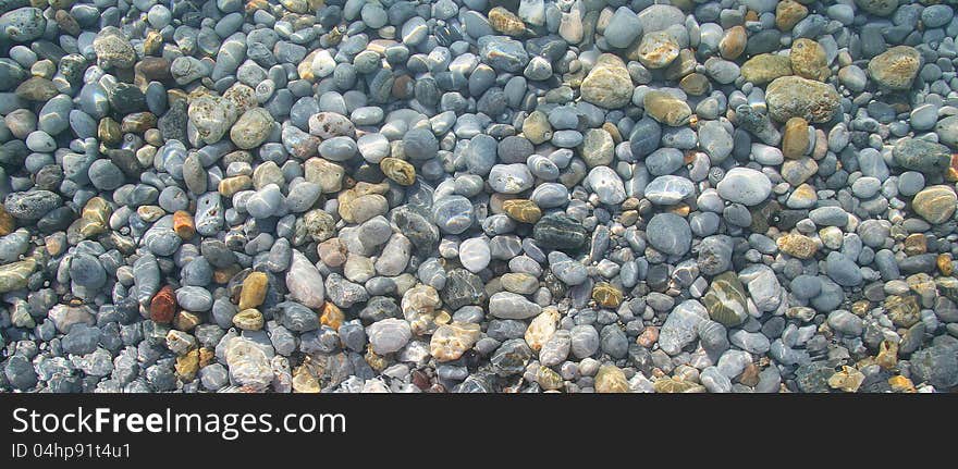 Pebbles in the sea water. Pebbles in the sea water