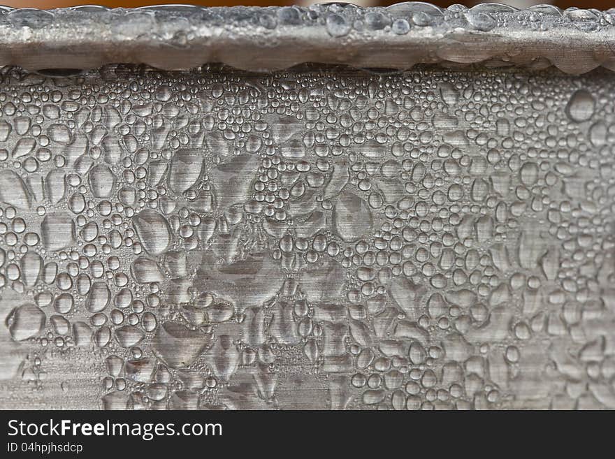 Water droplets, condensation on metallic ice bucket surface