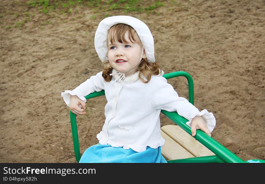 Llittle Girl Wearing Rides On Small Carousel