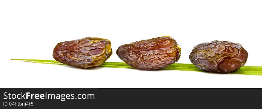 Ripe dates and leaf isolated on white background. Ripe dates and leaf isolated on white background