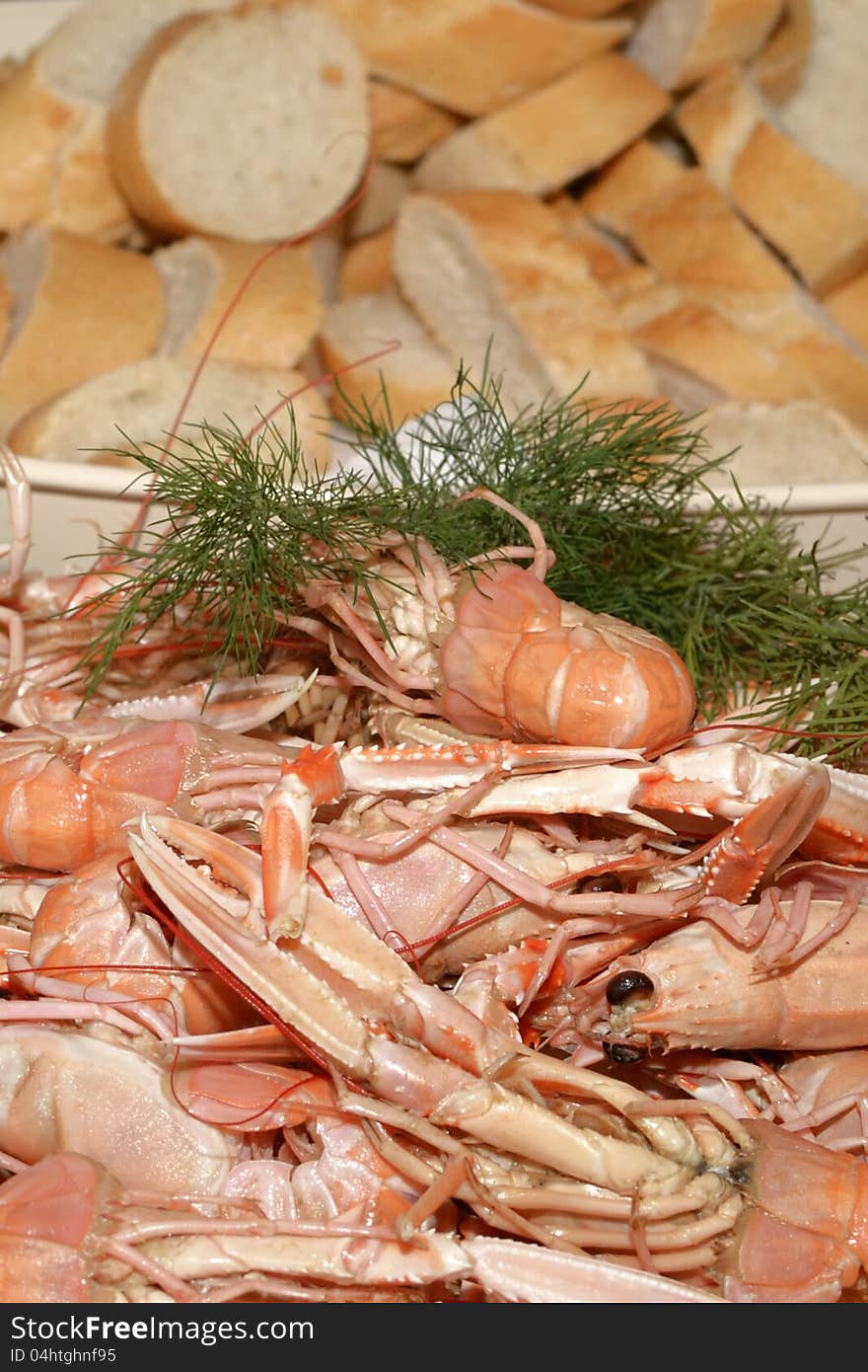 Crayfish and dill on a plate, bread int the background. Crayfish and dill on a plate, bread int the background