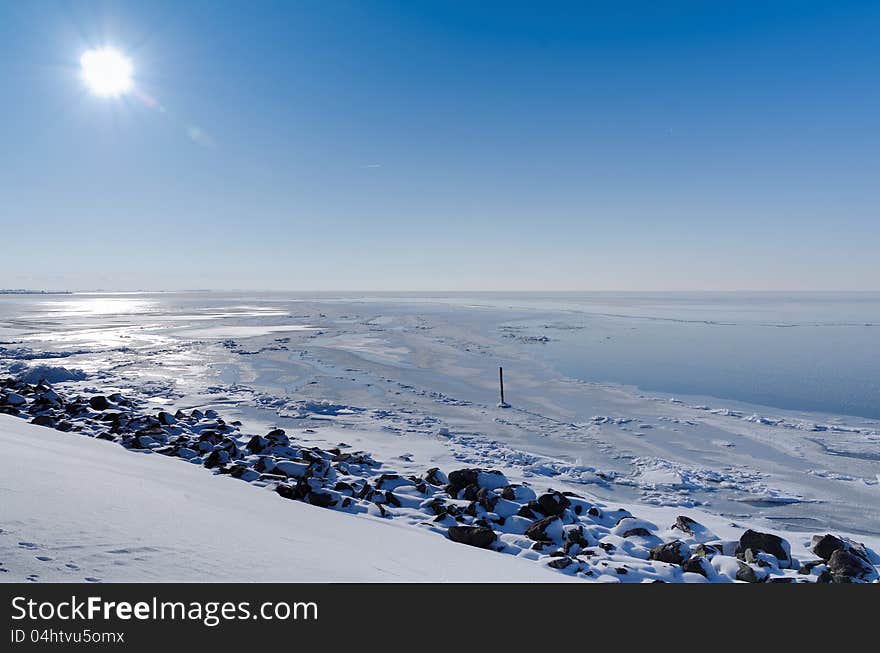 Sunny view across frozen lake