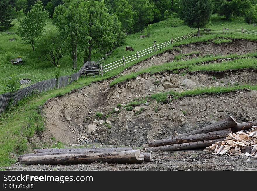 Cut branches at a wood exploitation and stored on a mountain valley