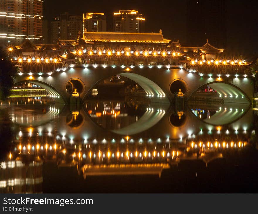 A chinese arch bridge ablaze with lights. A chinese arch bridge ablaze with lights