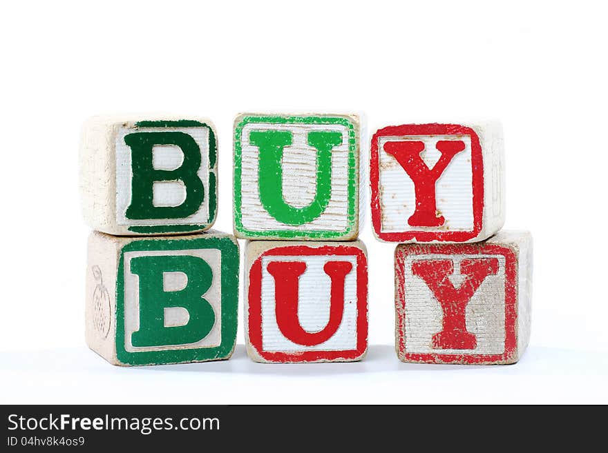 Wooden childrens blocks spelling 'buy'