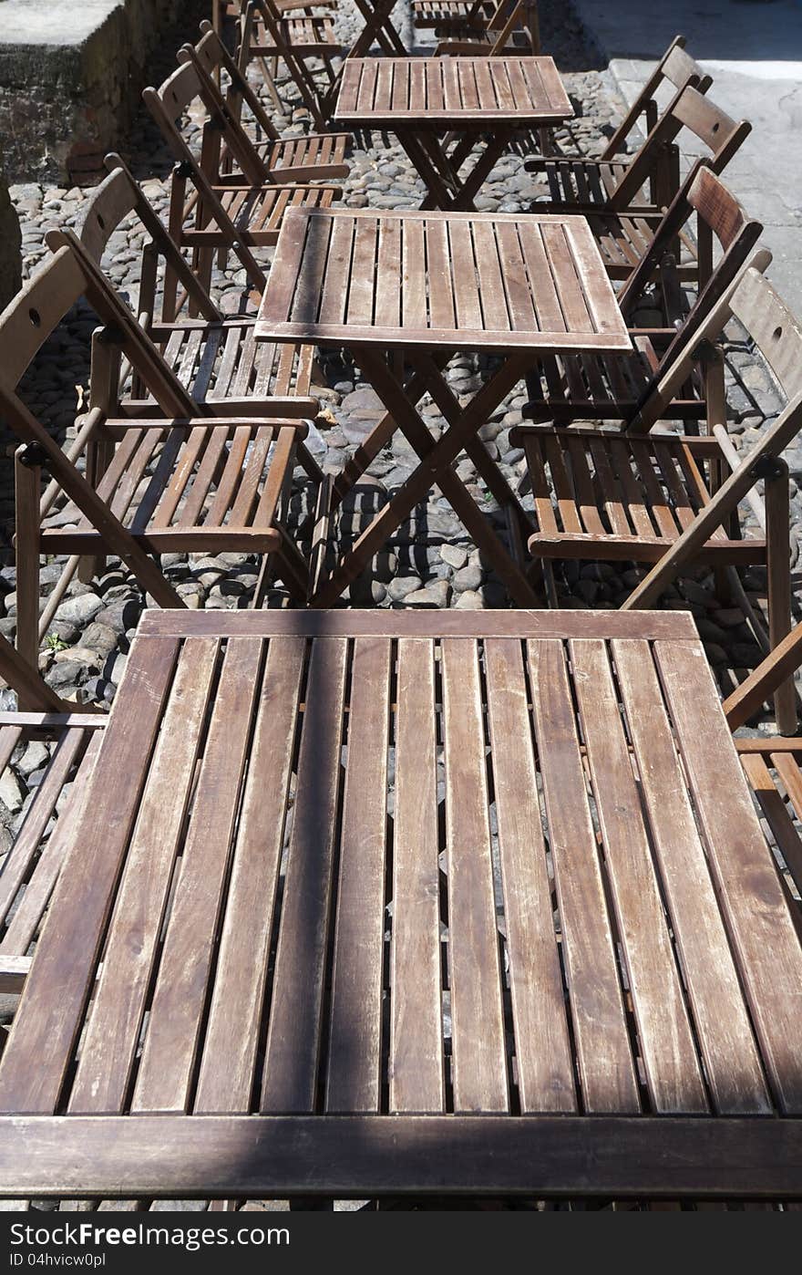 Group of wood tables outdoor restaurant ready to be served, Aviles, Asturias, Spain