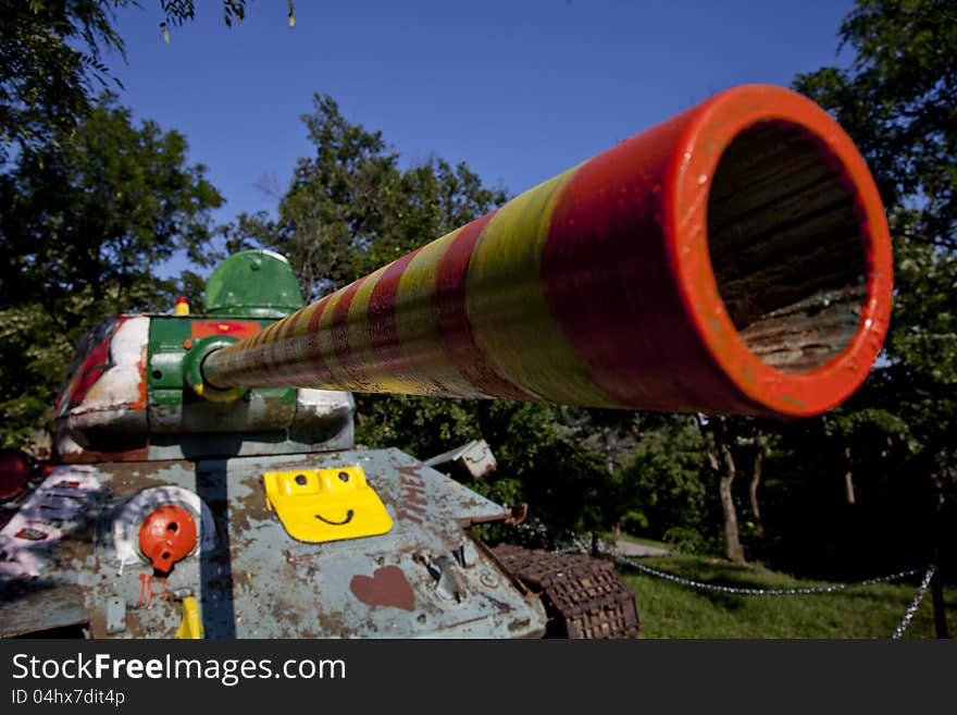 Old army tank painted by children in the garden. Old army tank painted by children in the garden