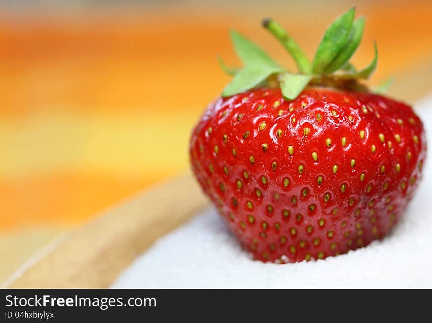 A strawberry is lying in sugar