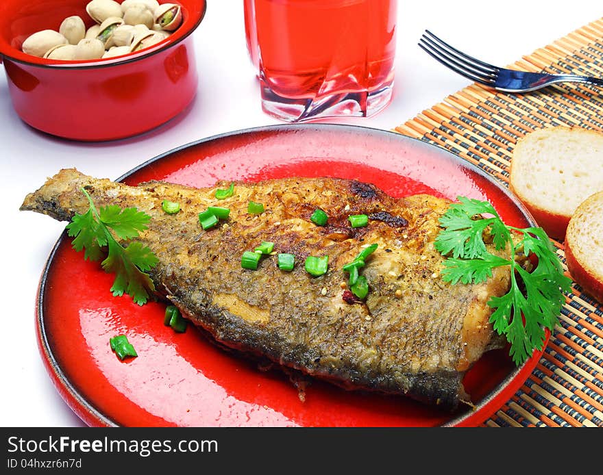 Dish of fried fish with fresh herbs