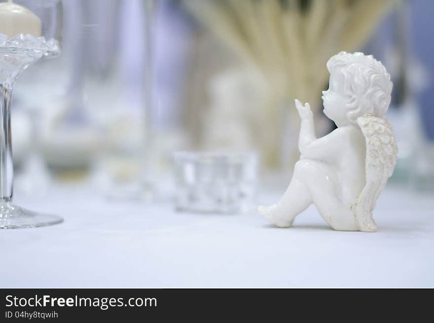 Romantic table set with angel, blurry background