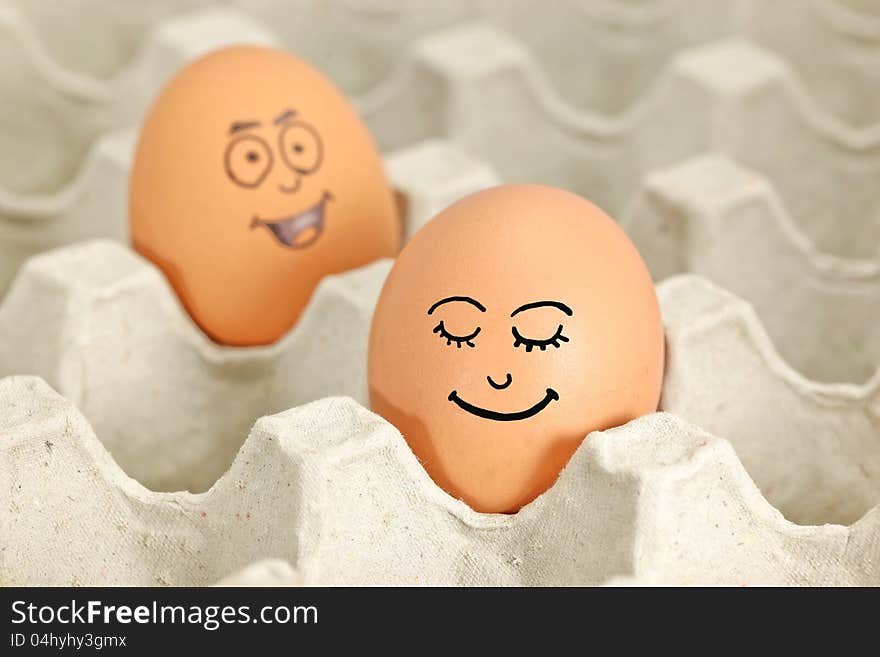 Eggs with emotion faces with tray. Eggs with emotion faces with tray