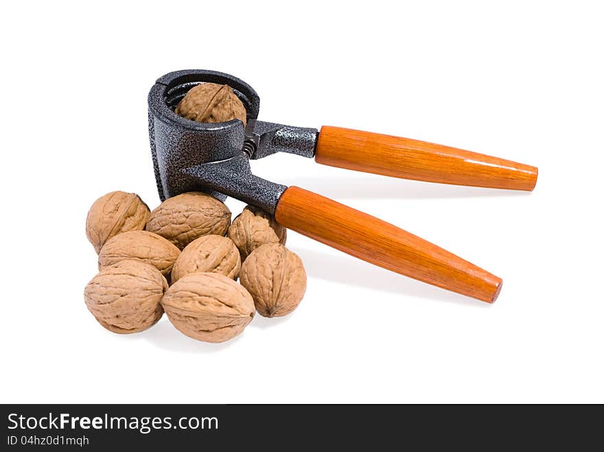 Nutcracker and walnuts on white background