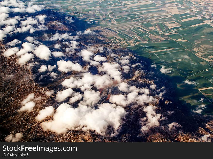 View of the mountains from an airplane above the clouds. View of the mountains from an airplane above the clouds