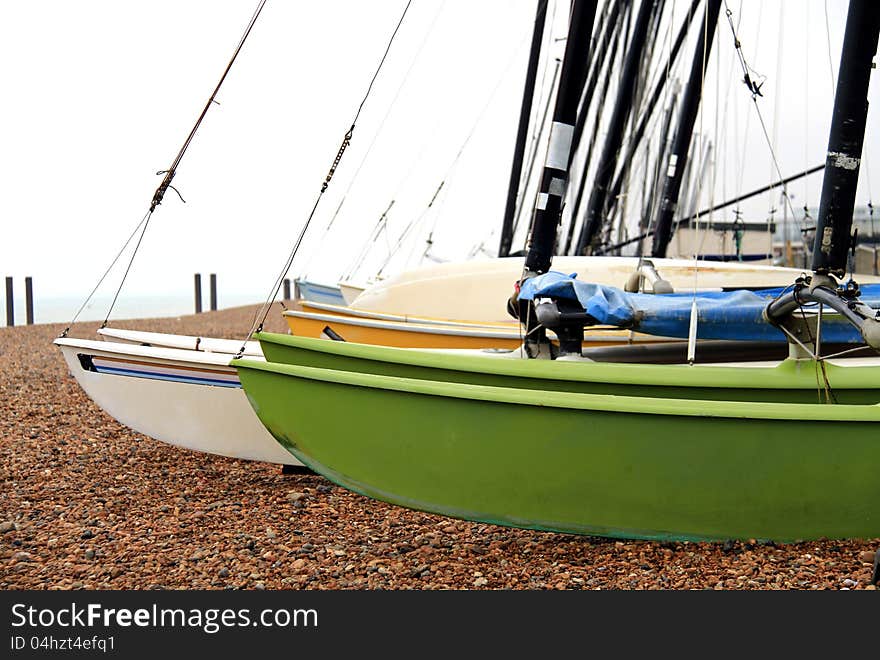 Image of sailboats on a pebbled beach