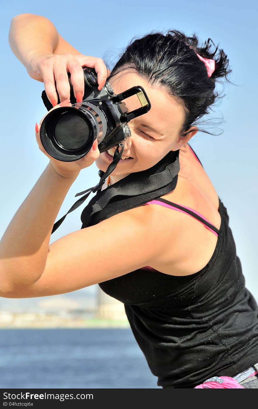 Young girl enthusiastically photographed while walking along the beach. Young girl enthusiastically photographed while walking along the beach