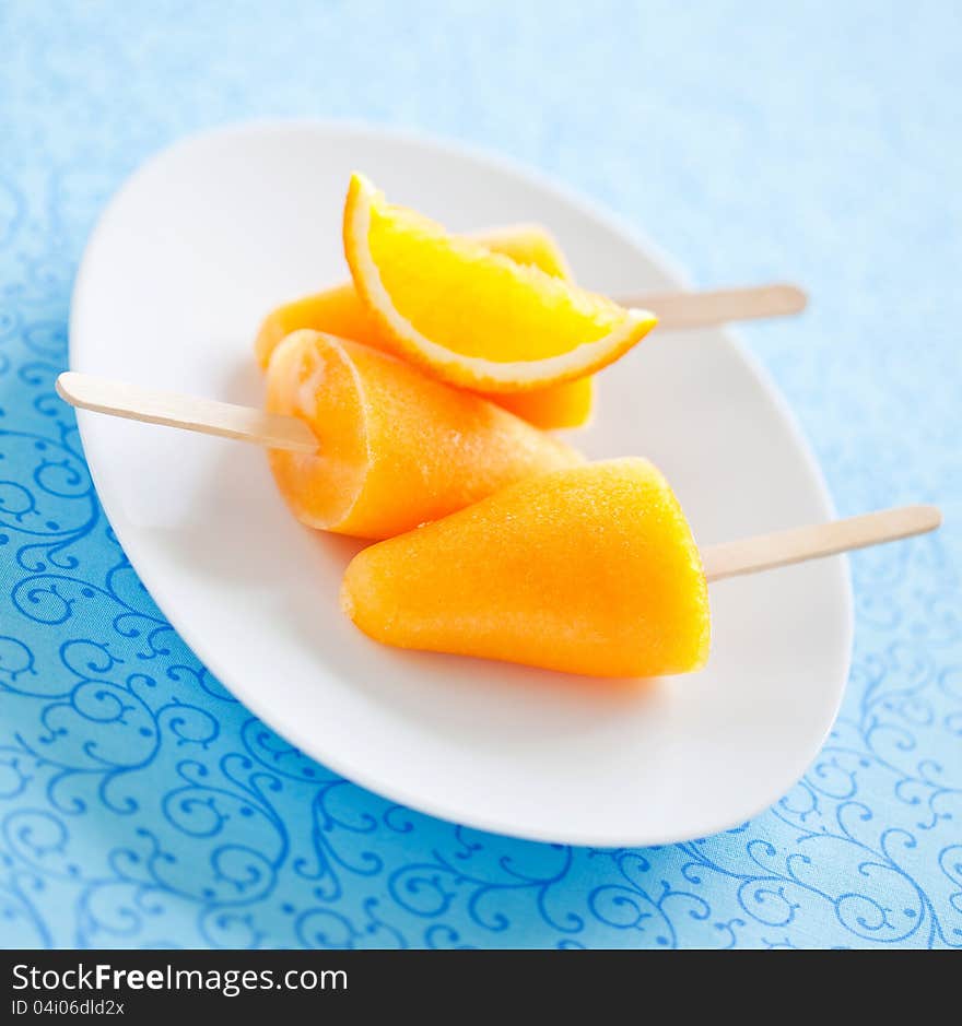 Orange ice lollies, selective focus