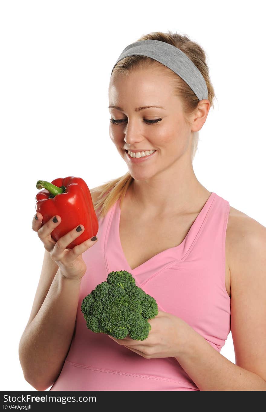 Young Woman holding a red pepper and broccoli isolated on a white background