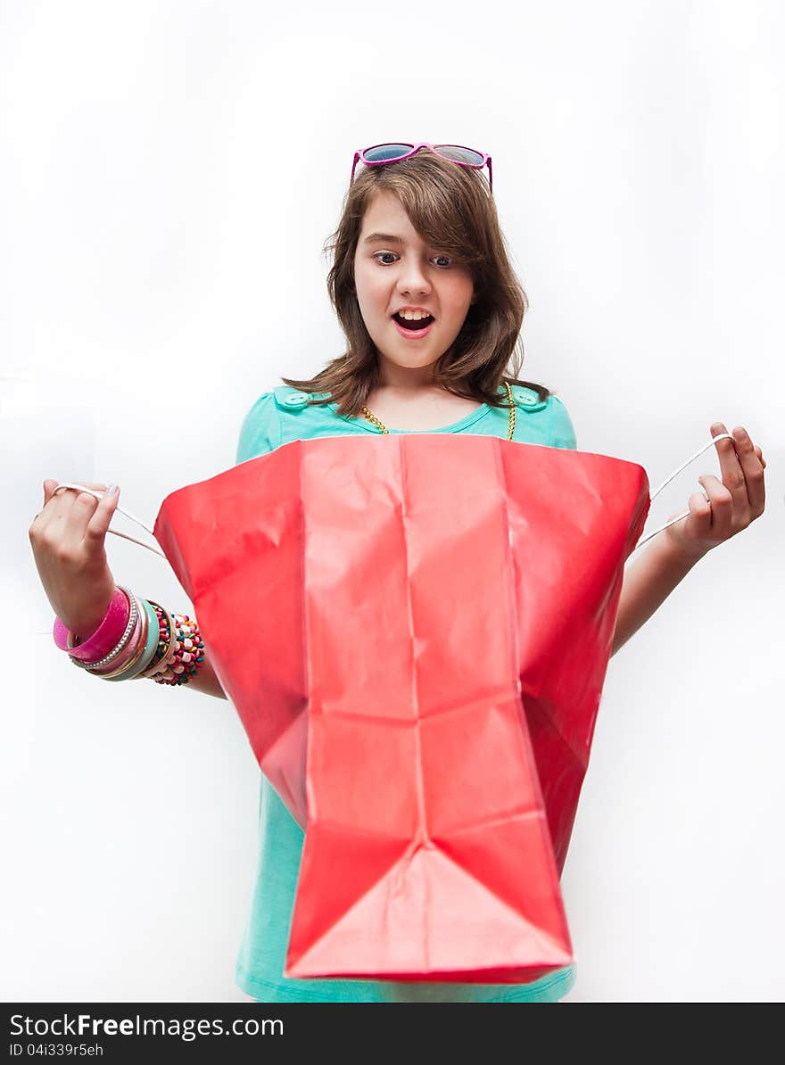 Teen girl with gift bags looking inside