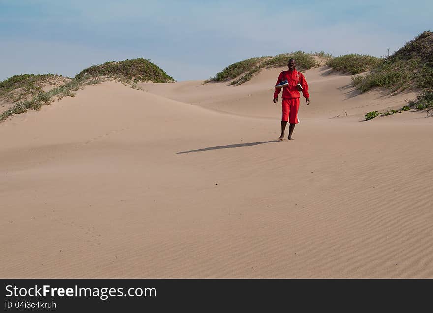 Man walking on sand dunes