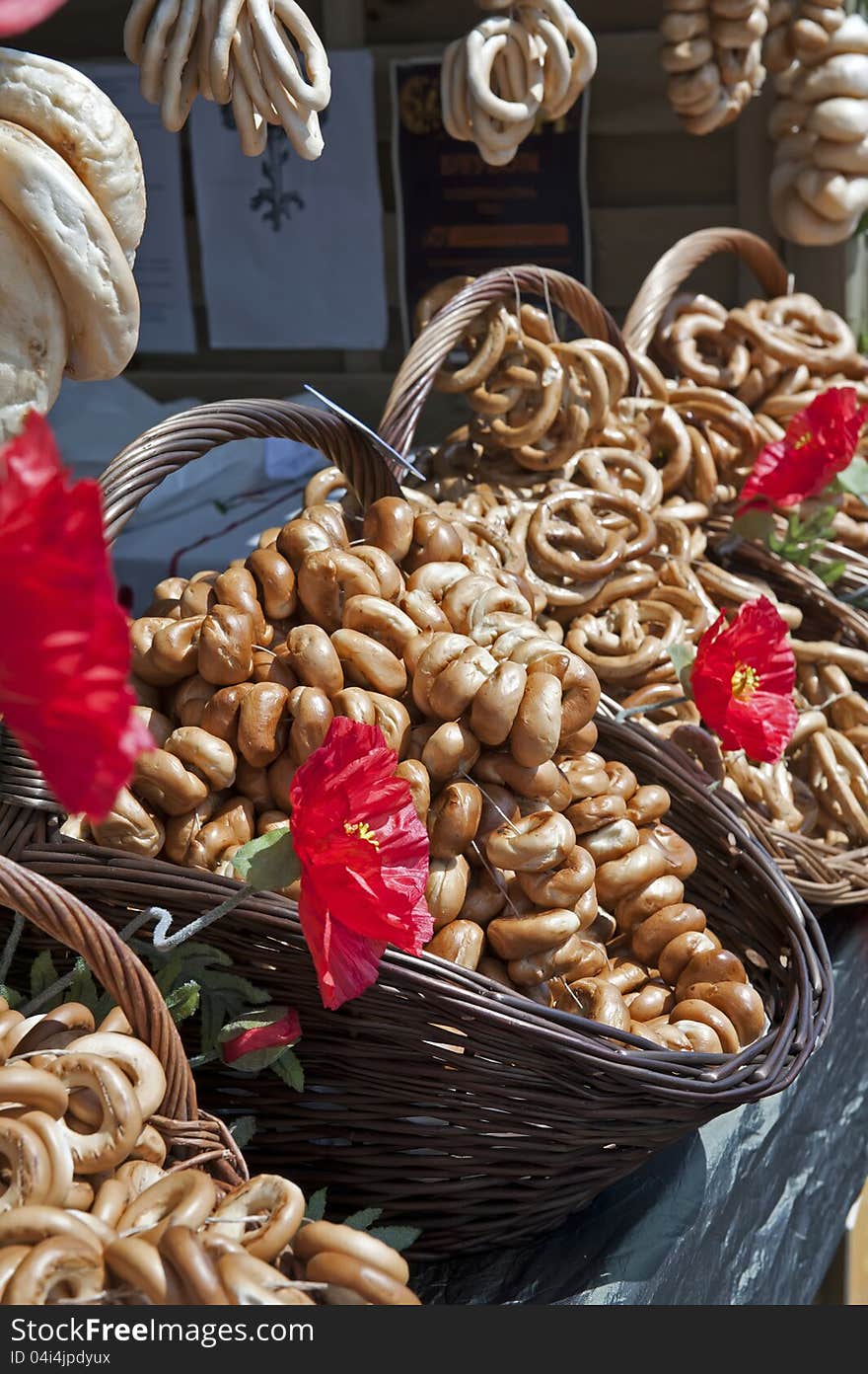 Piles of the pretzels displayed in the wicker bskets on a street market.