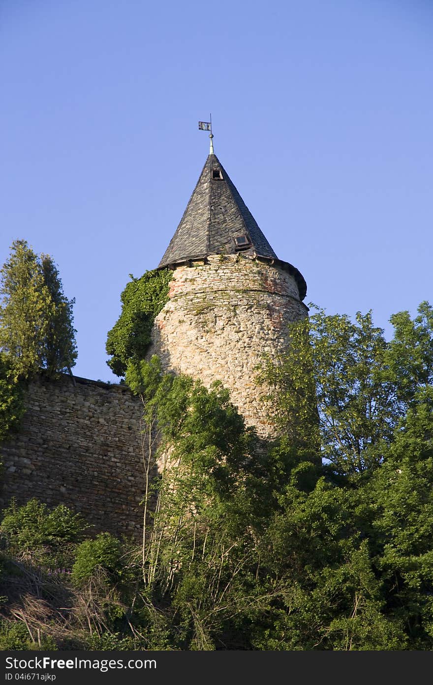 Tower with a piece of fortification for green trees. Tower with a piece of fortification for green trees