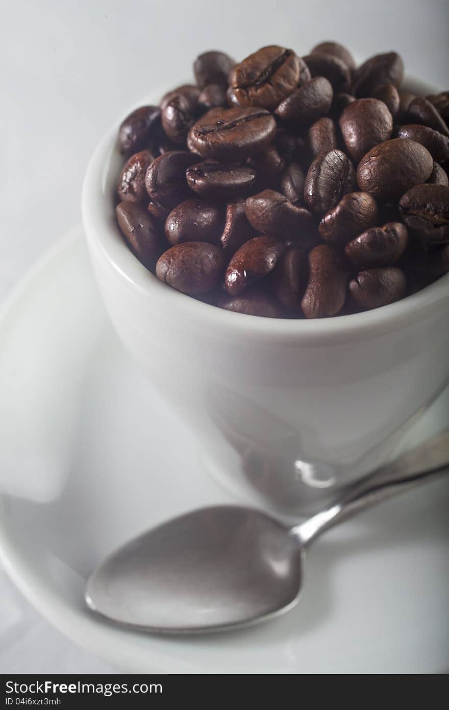 Cup full of coffee beans