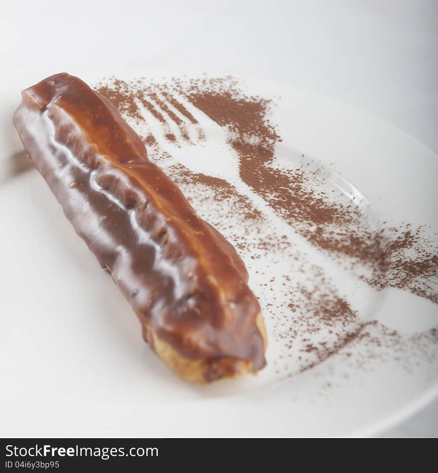 Eclair on a white saucer