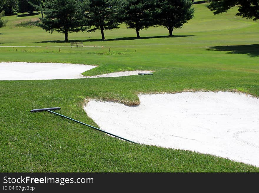 Gorgeous golf course with sand traps,trees and green grassy vistas. Gorgeous golf course with sand traps,trees and green grassy vistas.