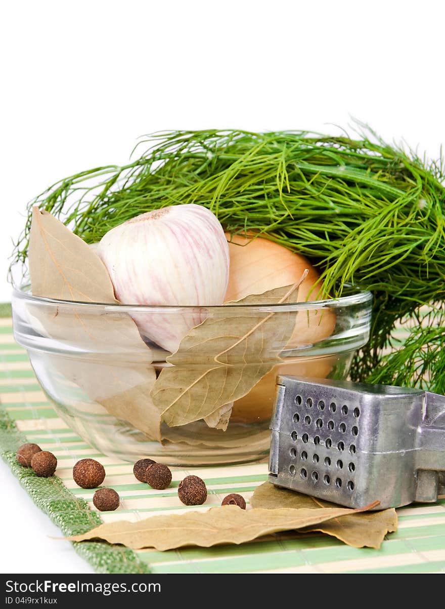 Dill lies on a garlic and onion in a dish