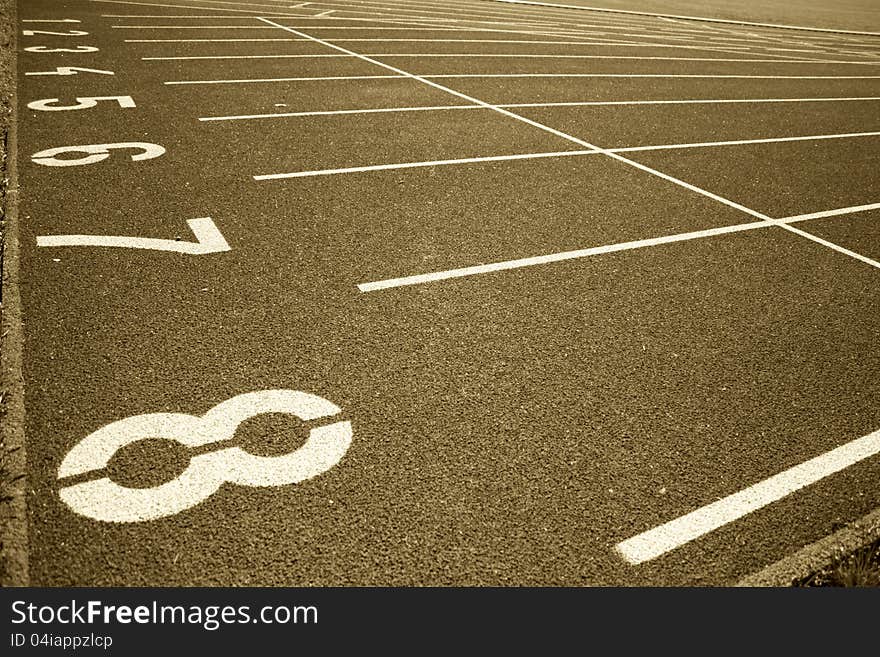 Details of numbers on the starting line running track, jogging track tinted in sepia