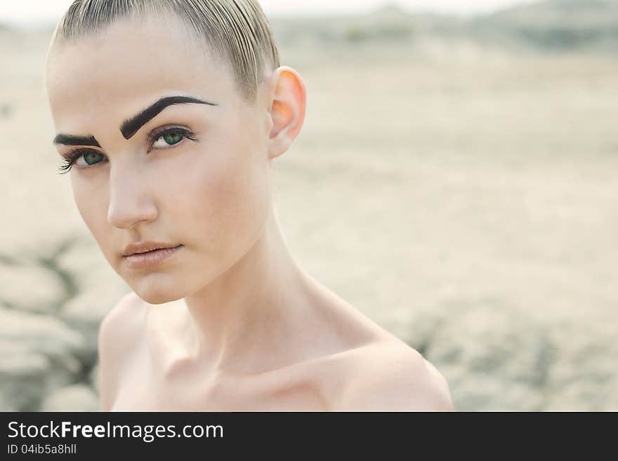 Fashion portrait of beautiful woman posing on lightfull background