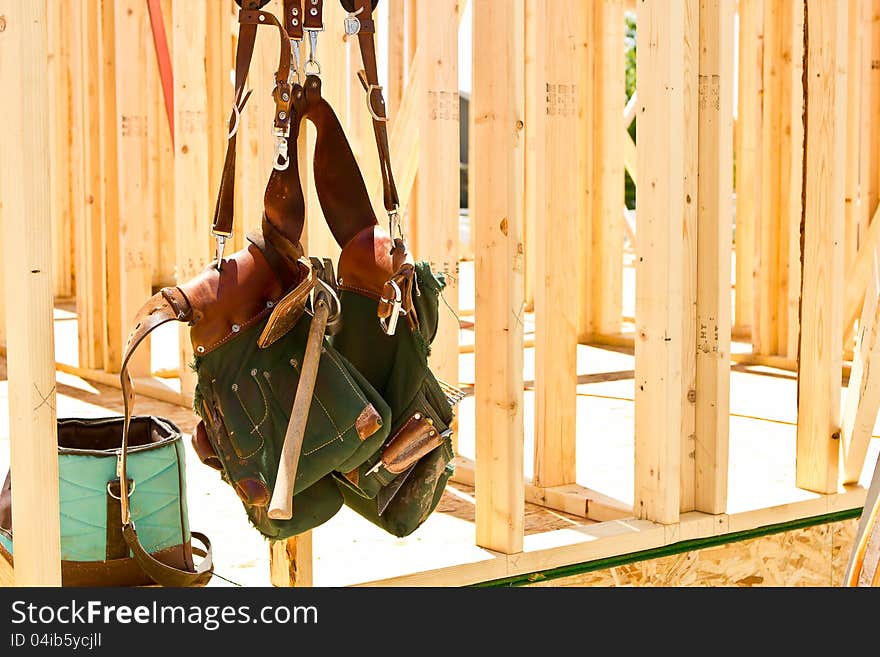 A tool belt full of construction tools to build a newly constructed home. A tool belt full of construction tools to build a newly constructed home.