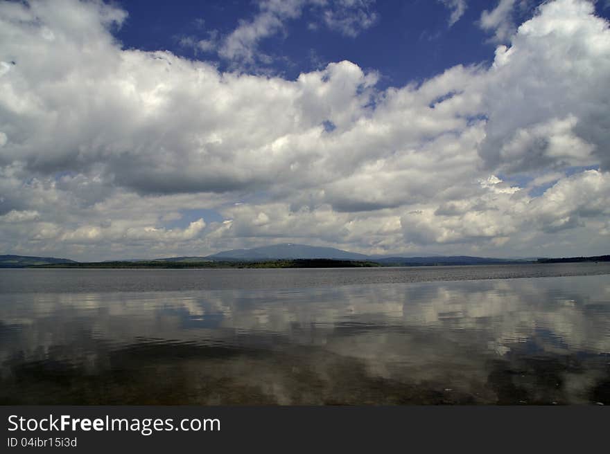 Reflections water sky clouds lake. Reflections water sky clouds lake