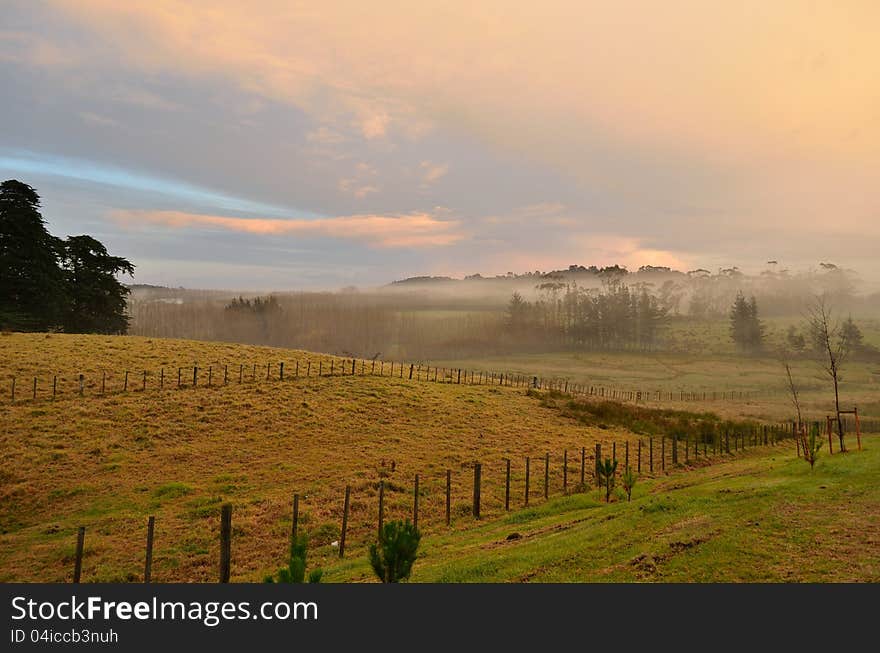 A misty morning over a rural area.