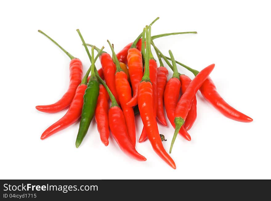 Arrangement of one green and heap red chili peppers isolated in white background. Arrangement of one green and heap red chili peppers isolated in white background