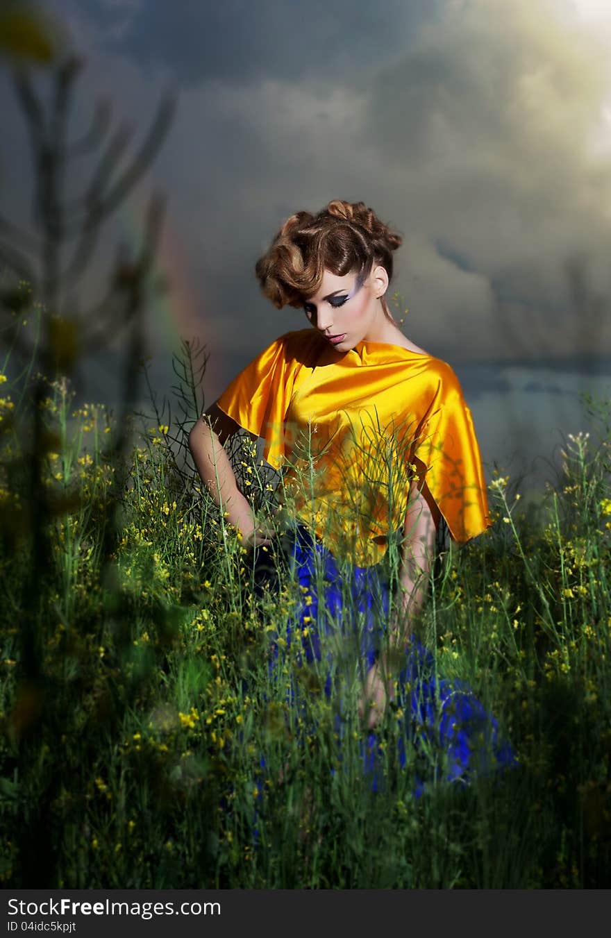 Nature. Fashion model standing in evening field