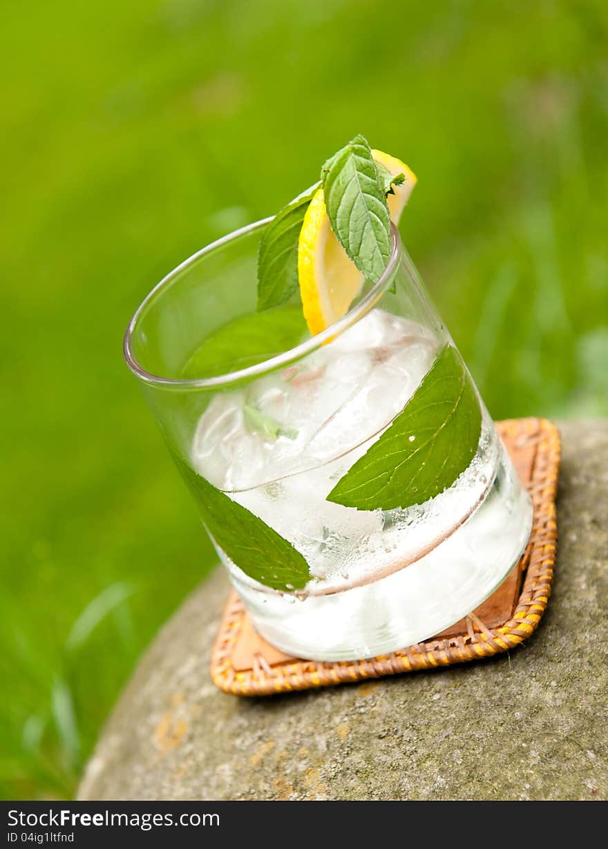 Rum cocktail on a stone in the garden in natural light