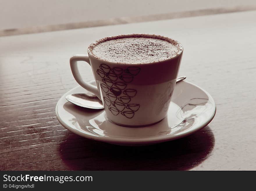 Coffee cup in cafe on brown wooden bench. Coffee cup in cafe on brown wooden bench