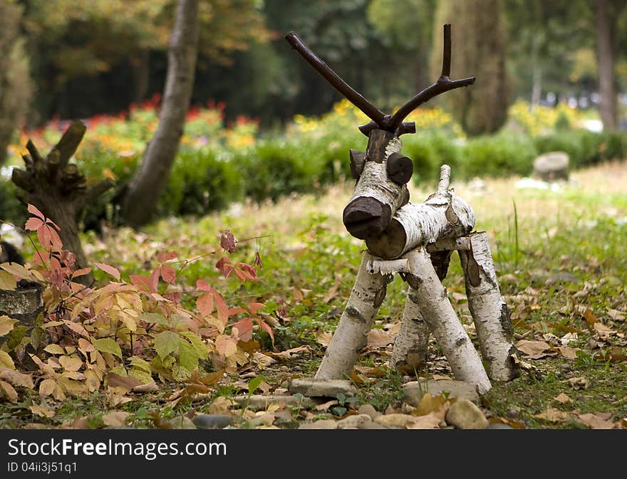 Folk arts - a figure of a wooden deer in the meadow