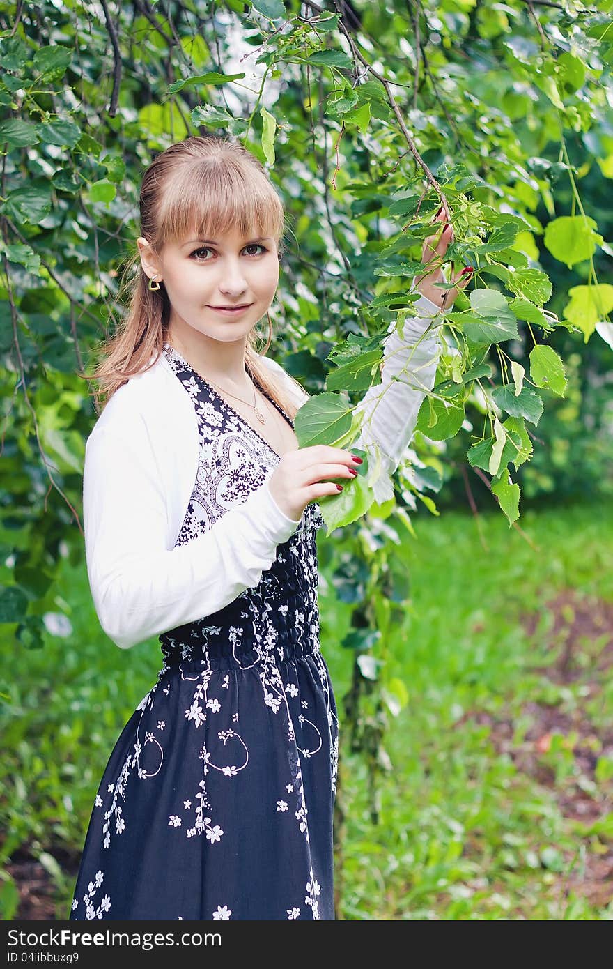 Girl near the linden tree. Girl near the linden tree