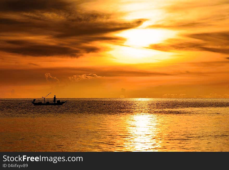 Fisherman on boat in the morning