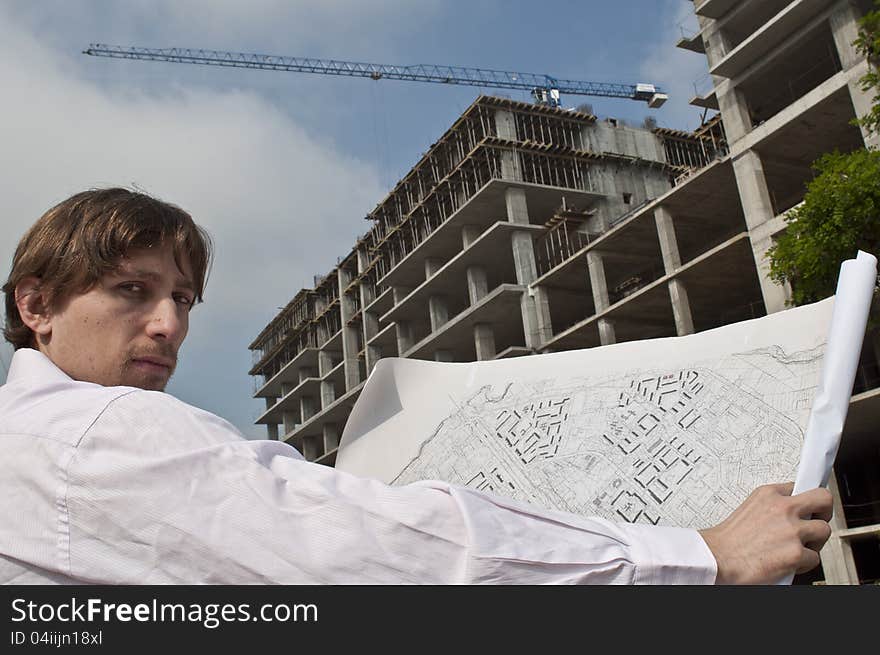 Low angle view of architect on construction site. Low angle view of architect on construction site