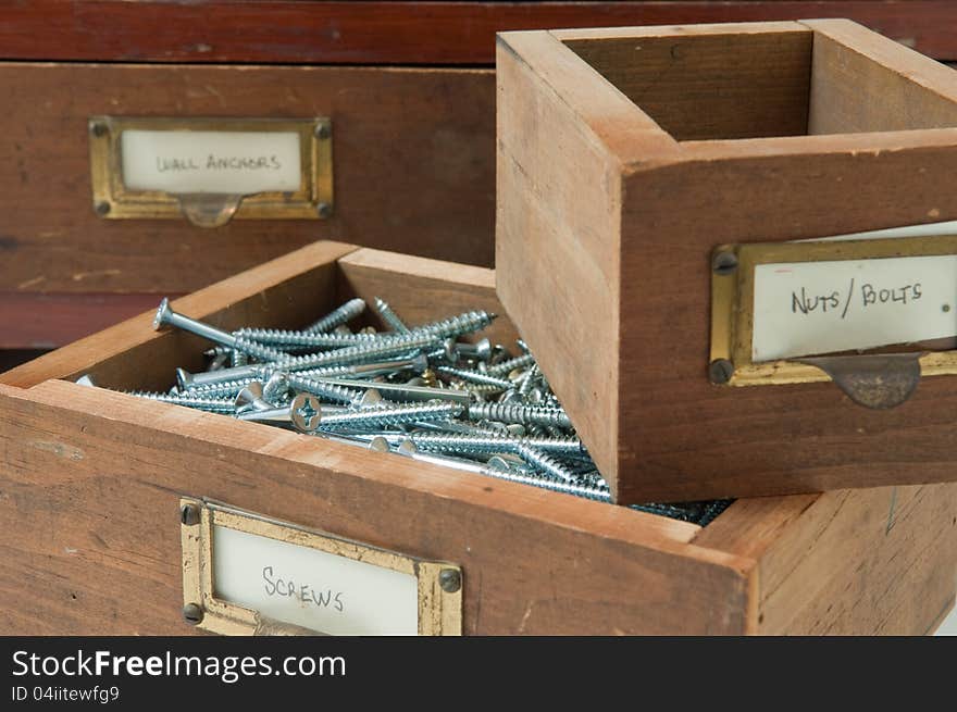 Antique wooden boxes hold various typs of small hardware. Antique wooden boxes hold various typs of small hardware